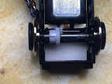 Cardstock to isolate capacitors from metal wiper tabs